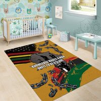 Yellow area rug with chains and slogan text over red, green, and black graphic bands