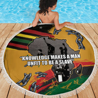 Round beach blanket with yellow graphic and text slogan, 'Knowledge makes a man'