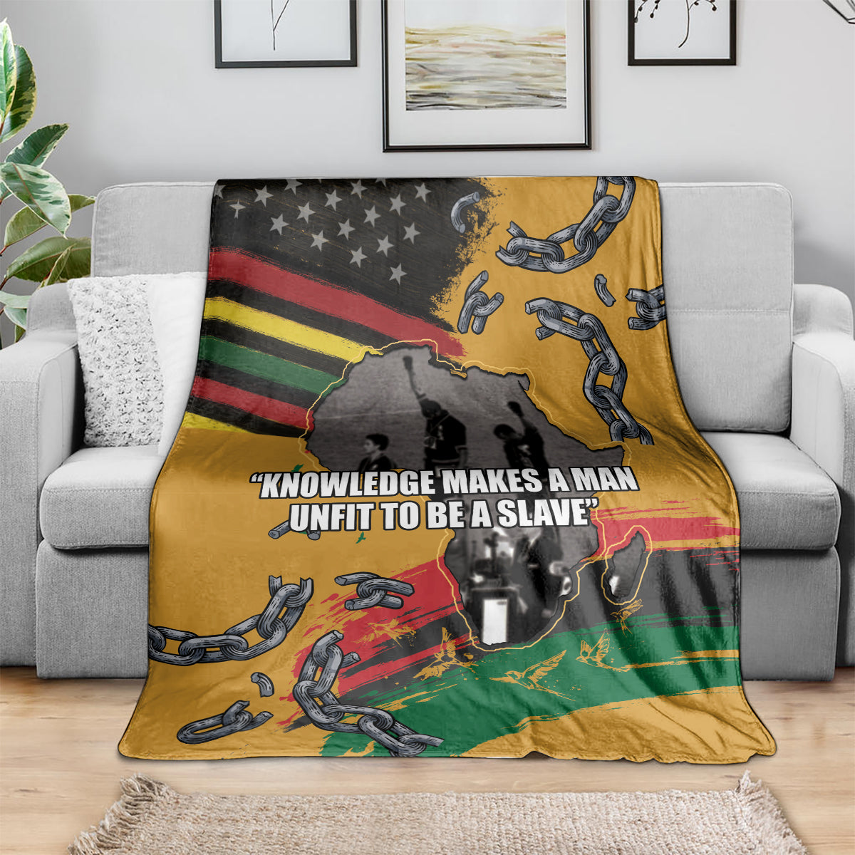 Juneteenth Freedom Day blanket on couch, yellow with African map, chains, and slogan