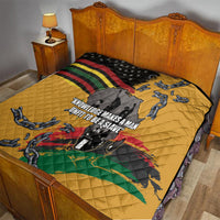 Yellow quilt on bed with black star section, rainbow stripes, chain graphics, and map artwork.