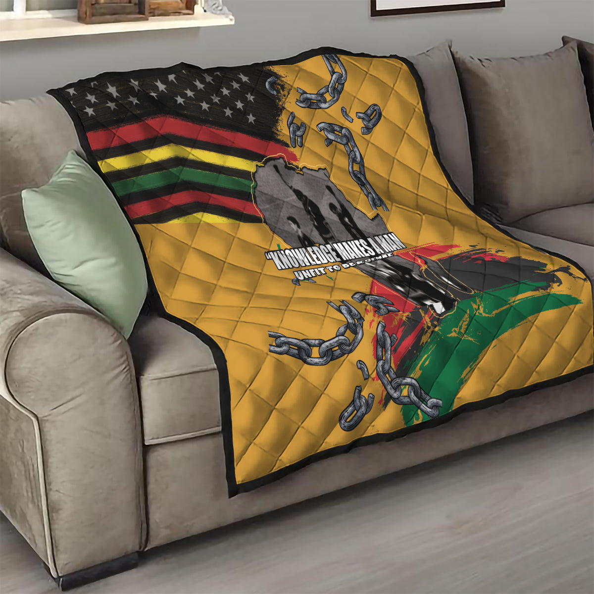 Yellow quilt draped on sofa with black star corner, rainbow stripes, chain motifs, and map.
