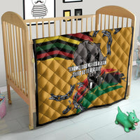 Yellow quilt in crib with black star corner, rainbow stripes, chain artwork, and map silhouette.