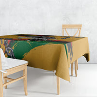 Yellow tablecloth with graphic chain motif and rainbow stripe pattern on table edge