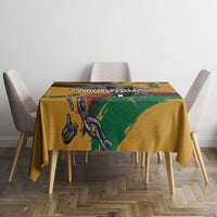 Yellow tablecloth with black, red, green chain-and-fist graphic across tabletop