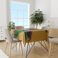 Yellow tablecloth with bold chain and rainbow stripe design on dining table