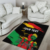 Black area rug with raised fist and chain pattern, diagonal red yellow green brush stripes