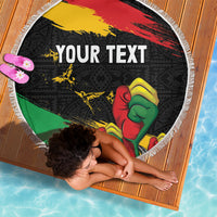 Round fringed beach blanket, black raised fist design with 'YOUR TEXT', laid flat