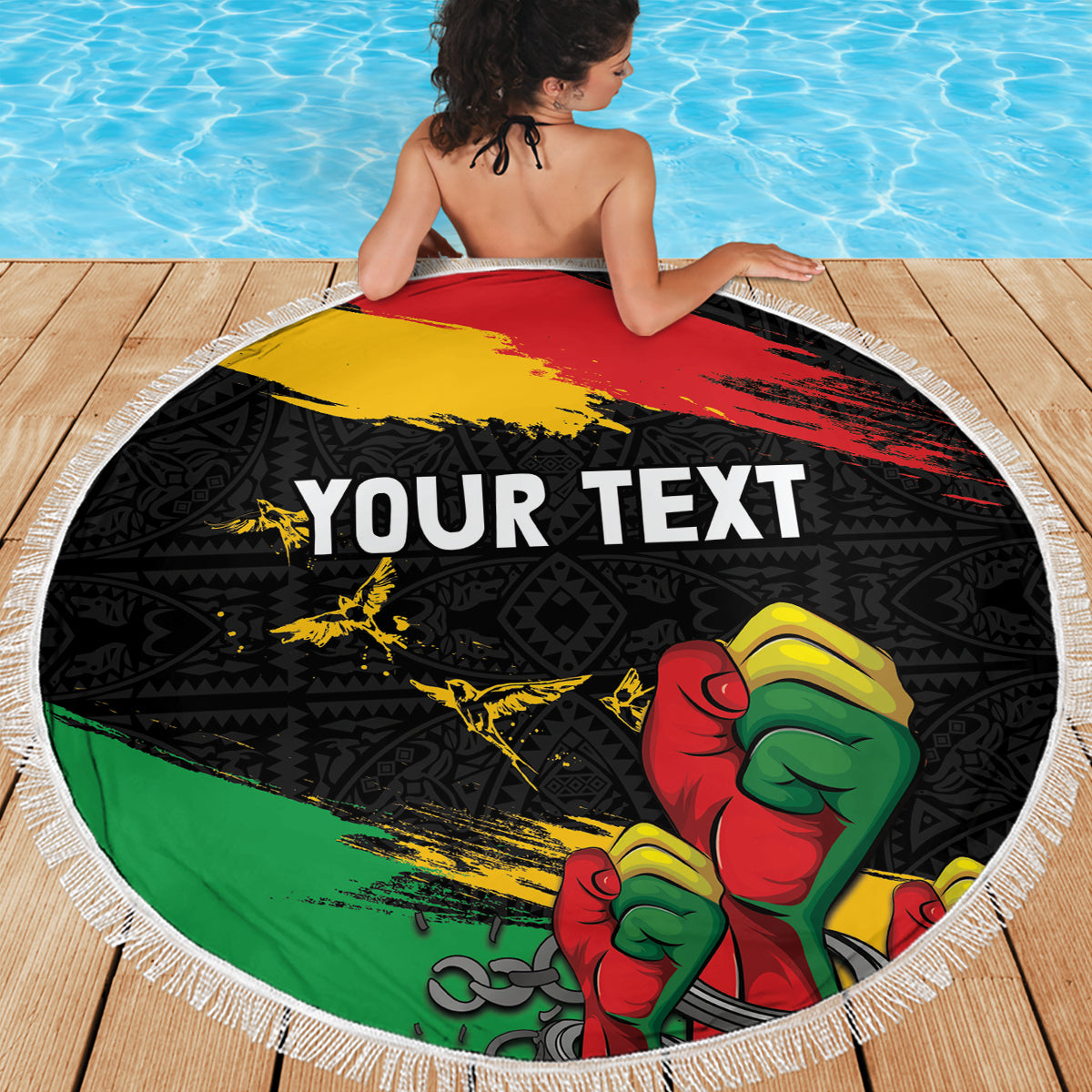 Round fringed beach blanket with raised fist artwork and 'YOUR TEXT' on wooden deck