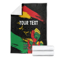 Black personalized blanket with 'YOUR TEXT' and raised-fist graphic, red-yellow-green diagonal stripes