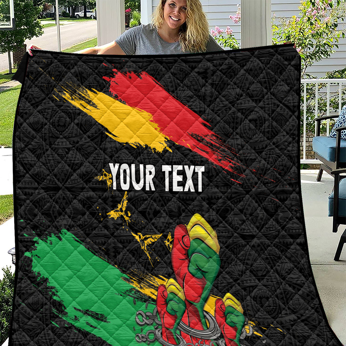 Black quilt with diagonal red-yellow stripes, green stripe, raised fist, and “YOUR TEXT”