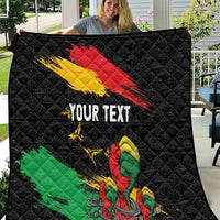 Black quilt with diagonal red-yellow stripes, green stripe, raised fist, and “YOUR TEXT”