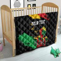 Black quilt on a crib with red-yellow diagonal stripe, green band, raised fist, “YOUR TEXT”