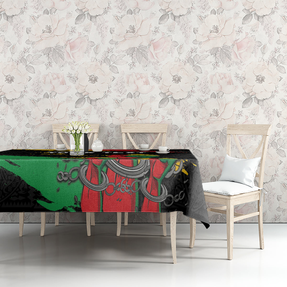 Black tablecloth with raised fist and ornate African-inspired pattern, laid over table.