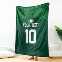 Green rugby-style blanket draped upright, showing 'YOUR TEXT' and white '10'