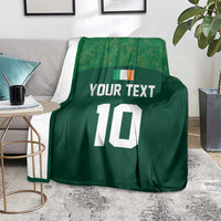 Green rugby-style blanket over chair, 'YOUR TEXT' and large white '10' print