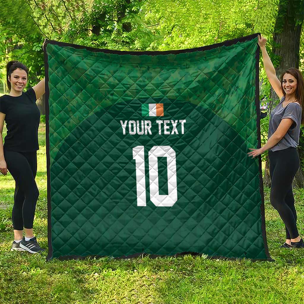 Green diamond-stitched quilt with custom text and number 10, draped outdoors