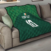 Green diamond-stitched quilt with custom text and number 12 on a couch