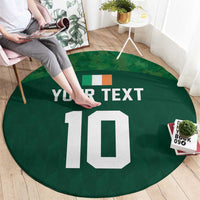 Green round rug with custom text and white number 10, people standing nearby