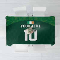 Green custom tablecloth with shamrock pattern and editable text panel, folded top view
