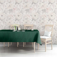 Green shamrock-pattern tablecloth on a long table with chairs and flowers
