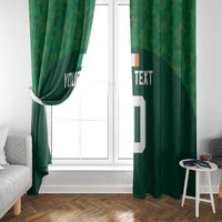 Green window curtain with custom text and white number 10, side tieback at left