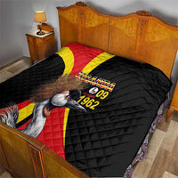 Black quilt on bed with Uganda crowned crane artwork and text "UGANDA 09 1962"
