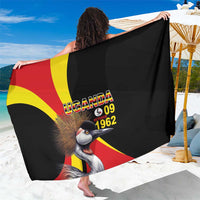 Black sarong with Uganda flag crest and crowned crane graphic, draped over shoulders