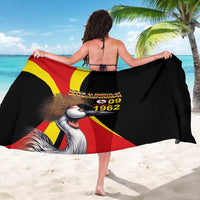 Black sarong with Uganda flag design and crowned crane graphic, worn back view