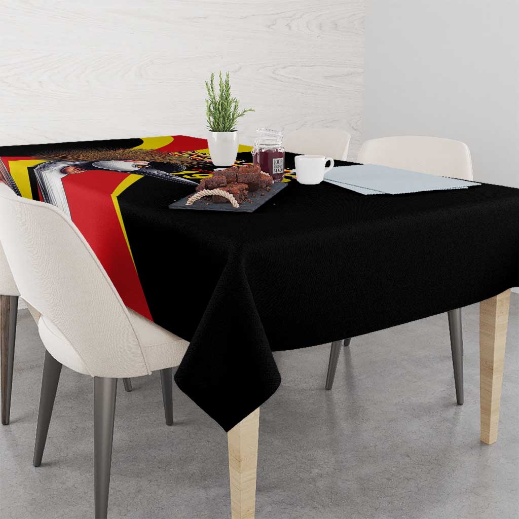 Black tablecloth on dining table with Uganda text and crowned crane graphic