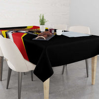 Black tablecloth on dining table with Uganda text and crowned crane graphic