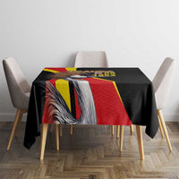 Black tablecloth on dining table featuring crowned crane and red-yellow flag stripe design