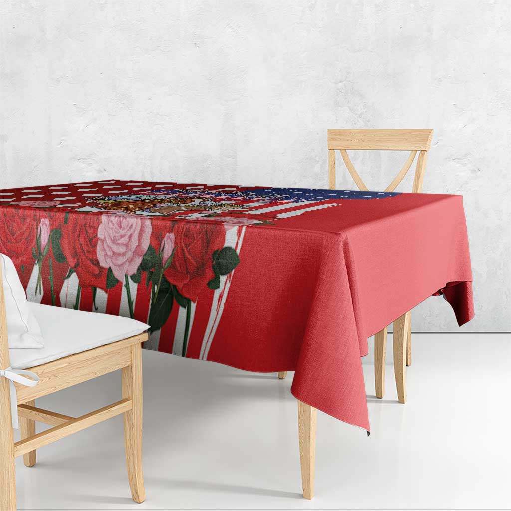 Red tablecloth with rose and US flag border pattern, draped over dining table