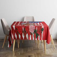 Red tablecloth with rose and diamond border, centered on dining table