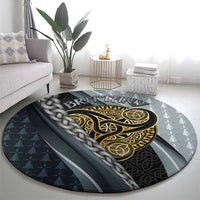 Round grey carpet featuring gold Celtic triskele design and braided knot pattern border.