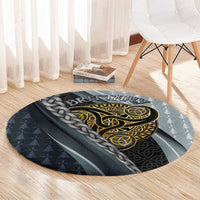 Round grey carpet with gold Celtic triskele graphic and braided knot border, corner view.