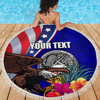 Round beach blanket held over shoulder, blue/red eagle and seal badge with hibiscus, white fringe.