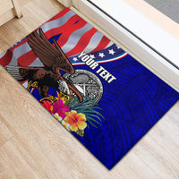 Blue rubber doormat showing US flag stripes, eagle, seal, hibiscus and polynesian pattern