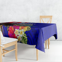 Blue Polynesian-style tablecloth with hibiscus flowers and geometric pattern, draped on table