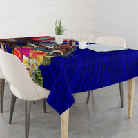 Blue tablecloth with tropical hibiscus flowers and repeating geometric motif on dining table