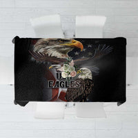 Black tablecloth close-up with eagle portrait and eagle-themed emblem graphic.