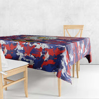 Square tablecloth draped over table with red, white, and blue camouflage flag pattern