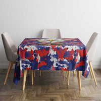Rectangular tablecloth with bold red, white, and blue camouflage flag print on table