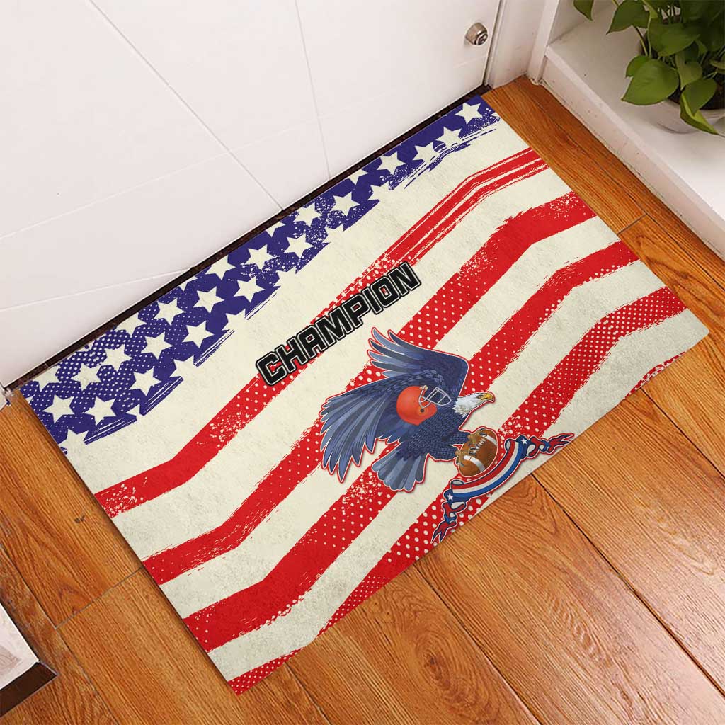 Red/blue rubber doormat on floor with stars, stripes, and eagle 'Champion' print