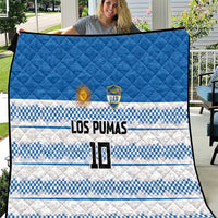Blue quilt with quilted texture, blue-and-white checker stripes, LOS PUMAS and crest