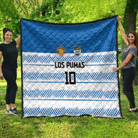 Blue quilt with quilted diamonds and blue-white checker bands, LOS PUMAS text and 10