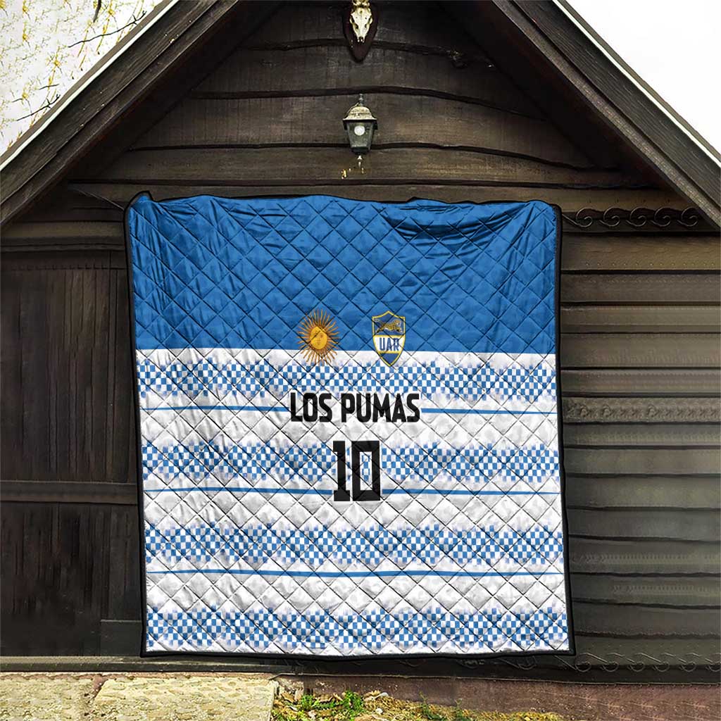 Blue quilt with quilted diamonds, blue-and-white checker stripes, LOS PUMAS lettering and crest