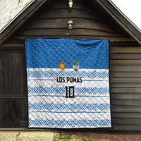 Blue quilt with quilted diamonds, blue-and-white checker stripes, LOS PUMAS lettering and crest