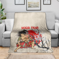 Beige throw blanket on sofa with samurai warrior graphic, red “Your Text”, and floral tree