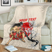 Beige blanket draped on armchair with samurai warrior, red “Your Text”, and cherry blossoms