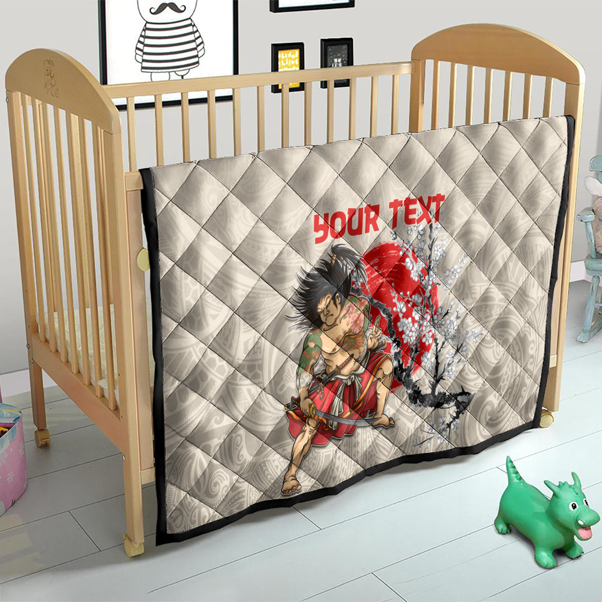 Beige quilt on wooden crib, diamond stitching with red “YOUR TEXT” and samurai cherry blossom art.